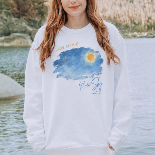 Woman wearing the Less Cloud, More Sky unisex crewneck sweatshirt by a lake