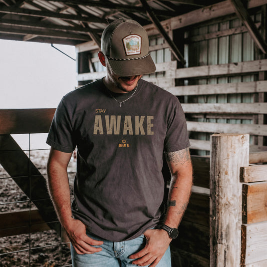 Man wearing the Stay Awake Comfort Colors T-shirt in distressed Pepper